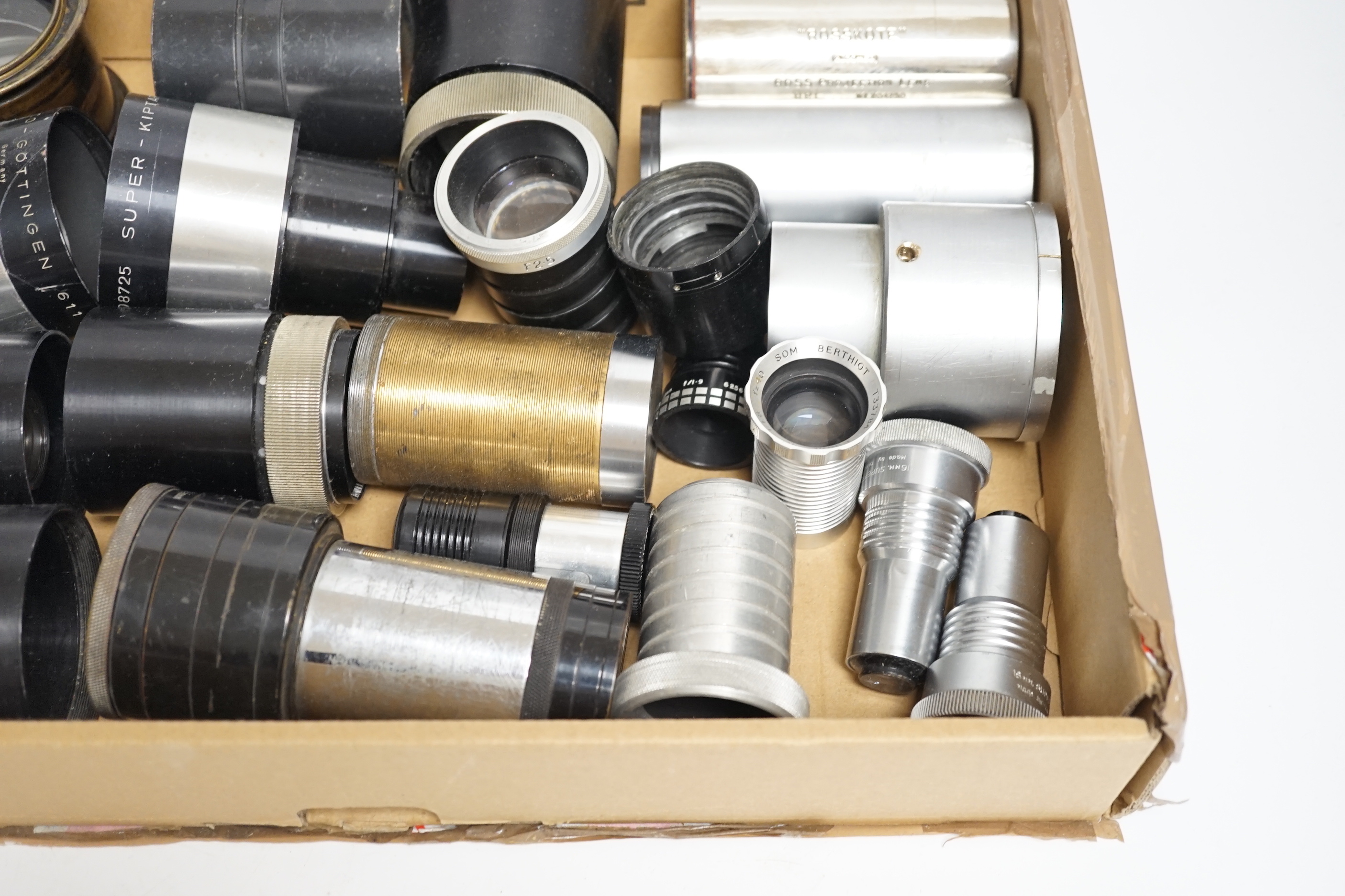 A collection of vintage cine camera lenses including examples by Taylor-Hobson, Super Six, Berthiot, Isco-Gotingen, Eumig, Ross, Gaumont Kalee, Aldis, etc.